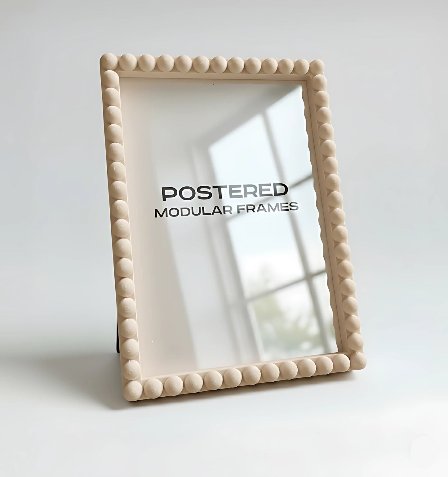 Beige framed mirror with 'POSTERED MODULAR FRAMES' branding on a light background